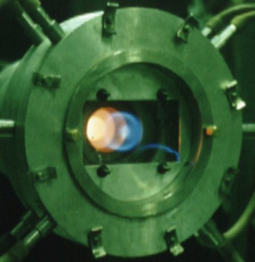 Combustion into vortex chamber